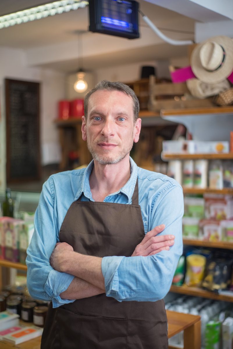 Independent retail business owner standing in a shop